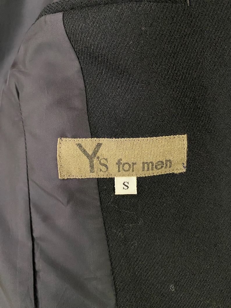 May include: A black Y's for men label with the size "S" printed on it.