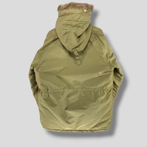 Puede incluir: Parka verde oliva con capucha forrada de piel. La chaqueta tiene cintura ajustable con cord&oacute;n y cierre de cremallera frontal. La parka est&aacute; dise&ntilde;ada para climas fr&iacute;os y tiene un corte holgado. Fabricada con material resistente al agua.