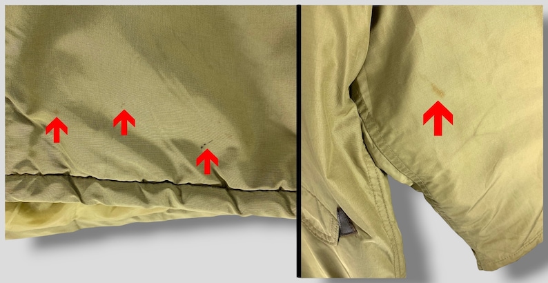 Puede incluir: Primer plano de una chaqueta verde oliva claro. La chaqueta muestra algunas manchas e imperfecciones menores. La tela parece ser un material ligero, posiblemente nailon o una mezcla sint&eacute;tica similar. La chaqueta tiene un dise&ntilde;o simple y utilitario.