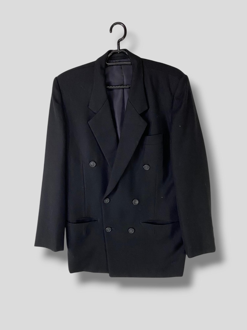 May include: A black double-breasted blazer with a classic cut and six buttons.