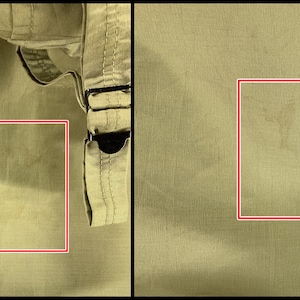 Puede incluir: Primer plano de una tela color caqui con manchas y arrugas visibles. La tela parece ser parte de una prenda, con una porci&oacute;n de un cintur&oacute;n y hebilla visibles en el lado derecho. La textura de la tela es ligeramente arrugada.