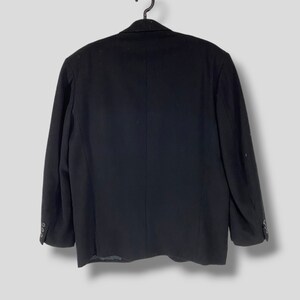 May include: A black blazer with a single button closure and long sleeves.