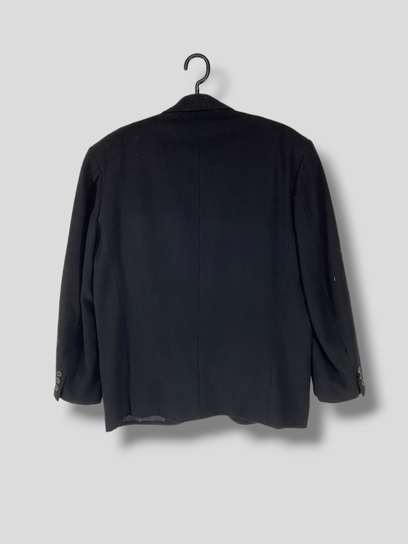 May include: A black blazer with a single button closure and long sleeves.