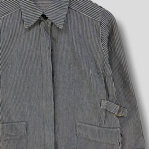 May include: A long-sleeved, striped shirt with a button-up collar and a single pocket on the left side. The shirt is made of a lightweight fabric and has a relaxed fit.