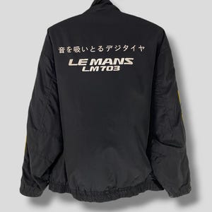 May include: Black jacket with a white embroidered logo that says "LE MANS LM703" and Japanese text that says "音を感じるテクノ" on the back.