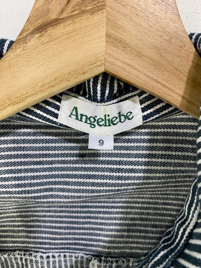 May include: A striped blue and white shirt with a green label that says "Angeliebe" and a size tag that says "9".