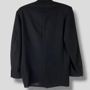 May include: A black blazer with a single button closure and long sleeves. The blazer has a classic, tailored fit.