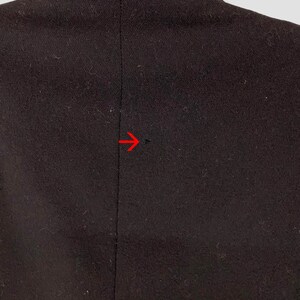 May include: A dark brown blazer with a single seam down the back.
