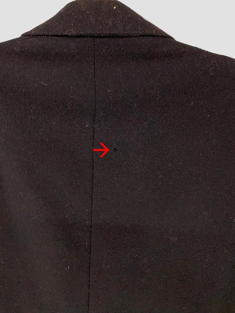 May include: A dark brown blazer with a single seam down the back.