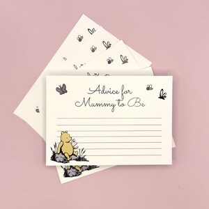 May include: A set of Winnie the Pooh themed baby shower advice cards. The cards are white with black lines and feature a drawing of Winnie the Pooh and Piglet. The text on the cards reads "Advice for Mummy to Be".