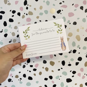May include: A white card with green leaves and a rabbit illustration. The card has the text "Advice for the parents to be" and "Love from" at the bottom.
