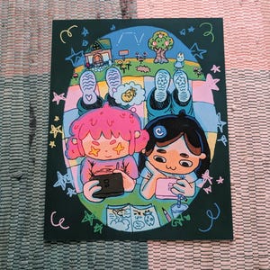 May include: A whimsical illustration featuring two cartoon figures lying on a picnic blanket, engrossed in handheld devices. The background depicts a serene landscape with a house, tree, and stars, all set against a dark green backdrop. The artwork is framed by decorative swirls and stars.