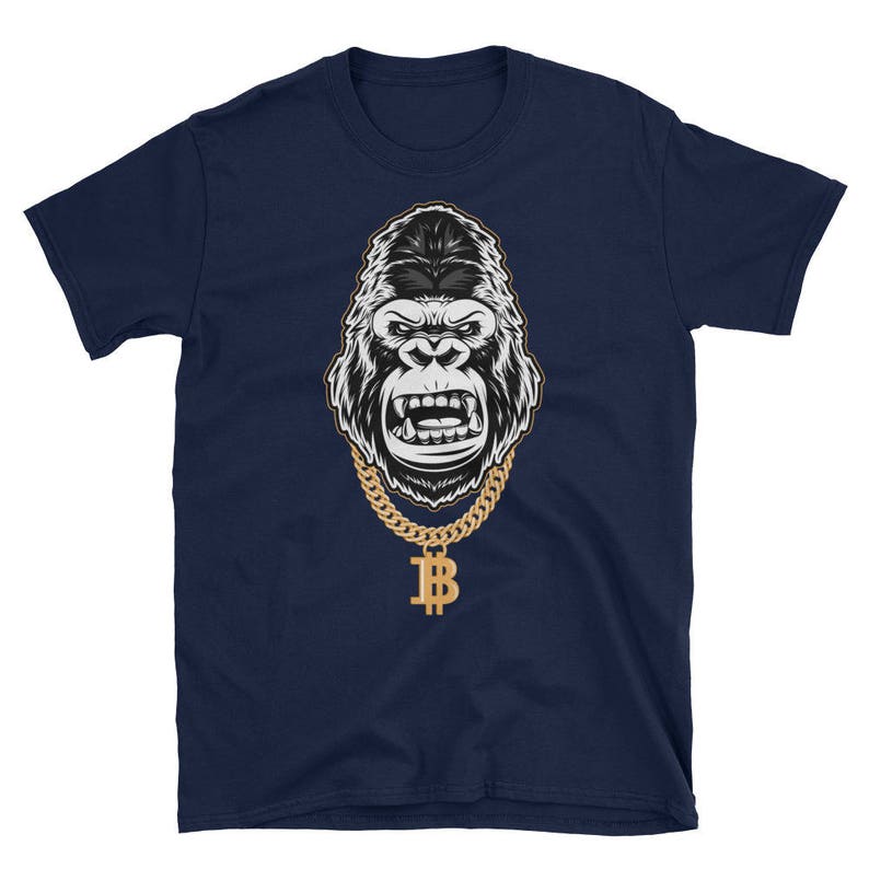 May include: A navy blue t-shirt featuring a black and white illustration of a gorilla wearing a gold chain with a bitcoin pendant.