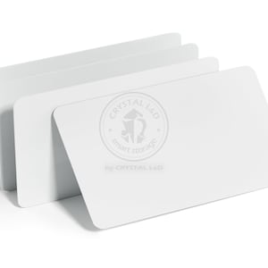 May include: Four white rectangular cards are stacked, with one card angled forward. The cards have rounded corners and a logo that reads "CRYSTAL L&D smart storage" in a circular design.