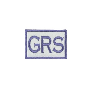 May include: A white embroidered patch with a blue border and the text "GRS" in blue.