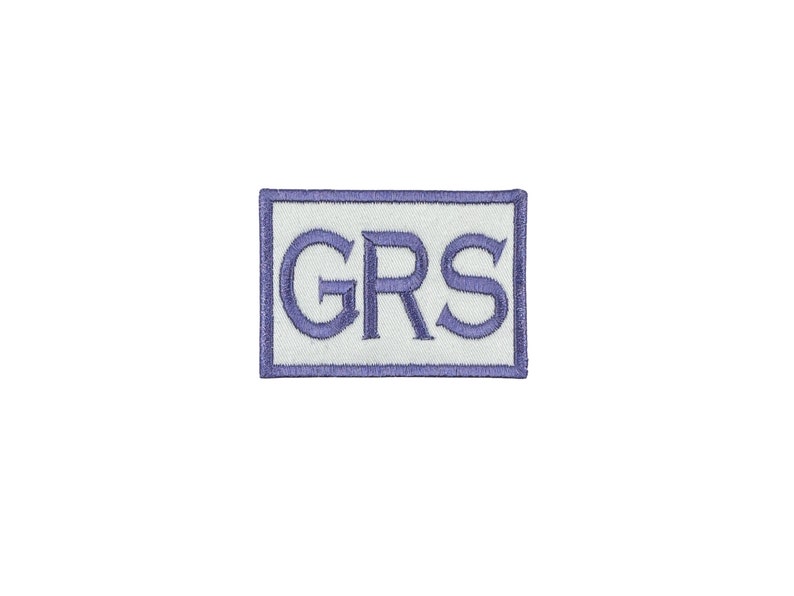 May include: A white embroidered patch with a blue border and the text "GRS" in blue.