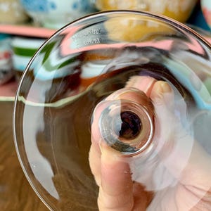 May include: Close-up of the bottom of a clear glass goblet with the words "Made in Germany" etched into the glass.