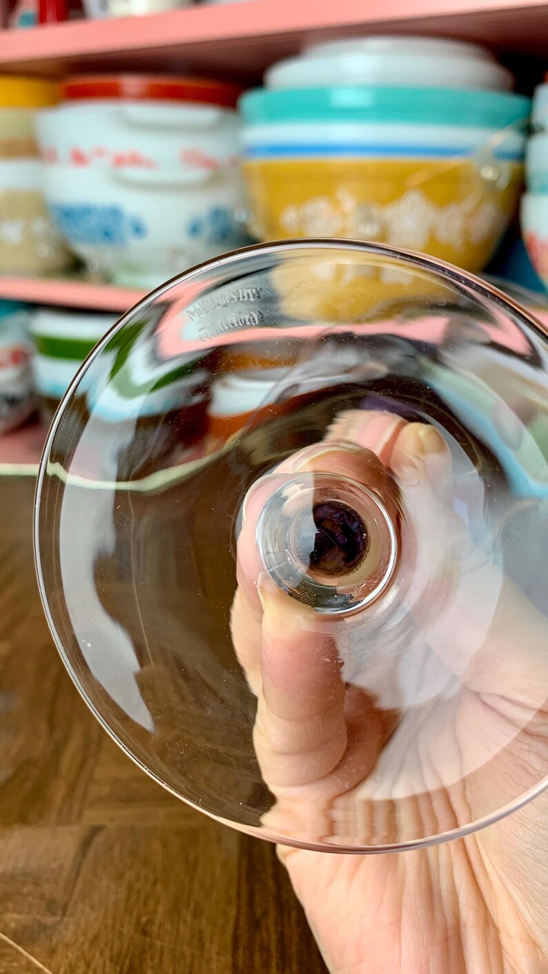 May include: Close-up of the bottom of a clear glass goblet with the words "Made in Germany" etched into the glass.
