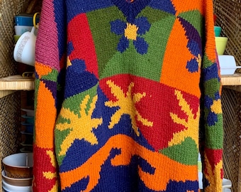 May include: A colorful patchwork knit sweater with a V-neck. The sweater features a variety of colors, including red, orange, yellow, green, blue, and purple. The sweater is decorated with a floral pattern and a geometric design.