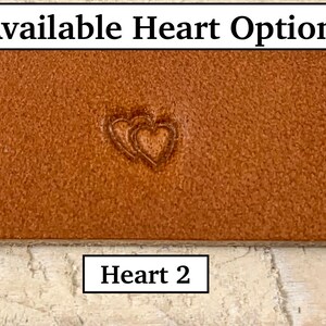 May include: Three different heart designs stamped into a piece of brown leather. The text "Available Heart Options:" is above the leather. The leather is labeled "Heart 1", "Heart 2", and "Heart 3" below each design.