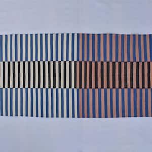May include: A long, rectangular rug with a striped pattern. The rug is divided into two sections, one with white and blue stripes and the other with pink and blue stripes. Both sections have a black and white stripe pattern in the middle.