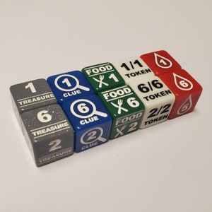 May include: A set of nine dice for a board game. The dice are in various colors, including gray, blue, green, white, and red. The dice have different symbols and numbers on them, including a magnifying glass, a treasure chest, a fork and knife, and a water drop.