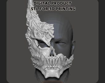 以下が含まれることがあります： 3Dプリントされたマスクのデザイン。半分が壊れていて、ギザギザで、質感のある顔の半分を持つ頭蓋骨。マスクは印刷して着用するように設計されています。画像の上部に「DIGITAL PRODUCT .STL FOR 3D PRINTING」というテキストがあります。
