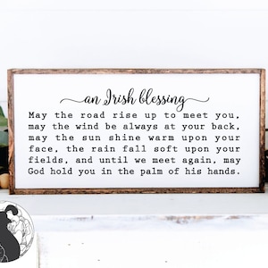 May include: A wooden sign with a white background and a brown frame. The sign features a black and white text that reads "an Irish blessing" and a traditional Irish blessing.