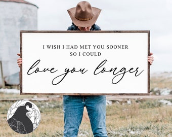 May include: A white wooden sign with the text "I wish I had met you sooner so I could love you longer" in black script font.
