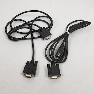 May include: Two black computer cables with connectors. One cable has two connectors, and the other has one connector. The cables are coiled and bundled together with a white tie. The connectors are black with silver pins.