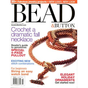 May include: The October 2004 issue of Bead & Button magazine features a cover with a long, beaded necklace in shades of red, orange, and gold. The necklace has a toggle clasp and a large, patterned focal bead. The cover text includes 'Crochet a dramatic fall necklace' and 'Beader's guide to gemstones'.