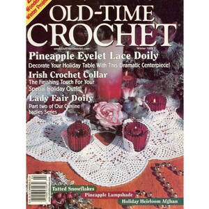 May include: The cover of "Old-Time Crochet" magazine, Winter 1998, features a white pineapple eyelet lace doily with red candle holders and a pink rose. Text includes "Pineapple Eyelet Lace Doily" and "Irish Crochet Collar."