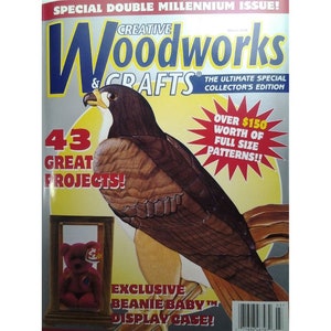 May include: A magazine cover for Creative Woodworks & Crafts, a special double millennium issue. The cover features a carved wooden hawk, a red beanie baby in a display case, and the text "43 Great Projects!" and "Over $150 Worth of Full Size Patterns!!"