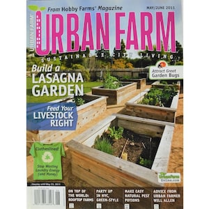 May include: A magazine cover for Urban Farm magazine, featuring a photo of a raised garden bed with a variety of plants growing in it. The cover text reads "Build a Lasagna Garden" and "Feed Your Livestock Right".