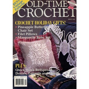 May include: A vintage crochet magazine cover with the title "OLD-TIME CROCHET." The cover features a pillow with a white crochet design, a cup of coffee, and text that reads "CROCHET HOLIDAY GIFTS!" and "Quick Work Bedspread."