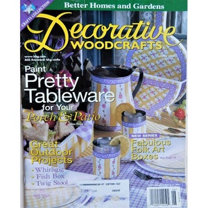 May include: A magazine cover for Decorative Woodcrafts, a publication of Better Homes and Gardens. The cover features a yellow and purple painted pitcher, a glass, and a basket. The headline reads "Paint Pretty Tableware for Your Porch & Patio".