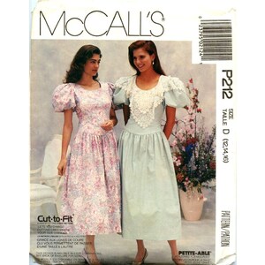 May include: A McCall's sewing pattern for a dress, size D (12, 14, 16). The pattern is for a dress with a lace collar and puff sleeves. The pattern is called "Petite-Able" and is labeled "Cut-to-Fit".