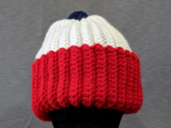 red poof ball hat