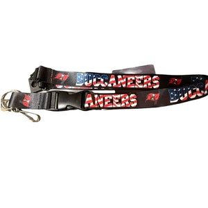 May include: Black lanyard with the words "Buccaneers" and "Aaneers" printed in red, white, and blue. The lanyard also features the Tampa Bay Buccaneers logo.