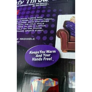 May include: Purple and white collegiate blanket with sleeves. The blanket is shown draped over a chair with a person sitting on it. The text "Keeps You Warm And Your Hands Free!" is printed on the blanket. The text "Collegiate Blanket with Sleeves by northwest&trade;" is printed on the packaging.