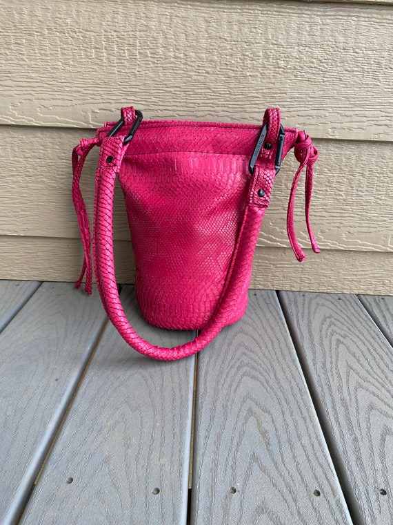 SIDEWINDER Vinyl faux python bucket bag with rounded shoulder strap and spring links. Etsy