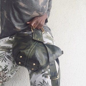 KNOCK KNOCK- Unique wristlet tote in camouflage print leather with detachable/ adjustable shoulder strap.