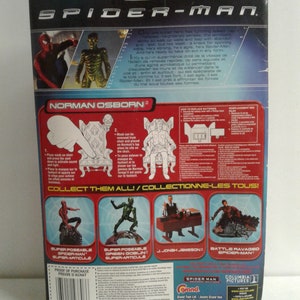May include: A Spider-Man action figure packaging featuring a red and blue Spider-Man, a green Goblin, and a red and black Norman Osborn. The packaging includes the text "Collect Them All!" and "Collectionne-les Tous!" and shows other figures in the series: Super Poseable Spider-Man, Super Poseable Green Goblin, Jonah Jameson, and Battle Ravaged Spider-Man.