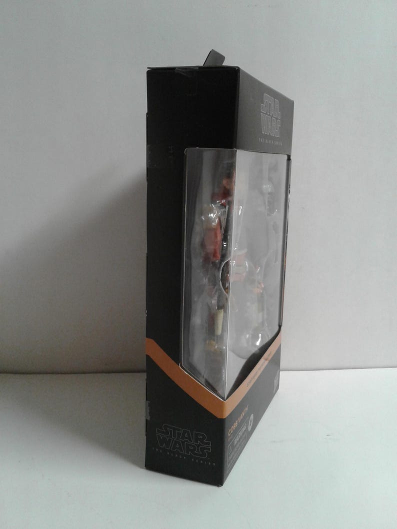 May include: A black and orange Star Wars The Black Series action figure box featuring a character named "Cobb Vanth".