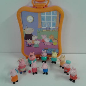 May include: A Peppa Pig playset with a carry case depicting a classroom scene, and several Peppa Pig character figures. The case is orange and pink, and the figures are dressed in different outfits.