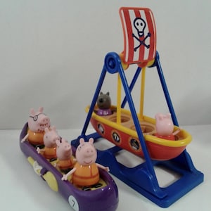 May include: A Peppa Pig themed toy set. It features a purple car with four pig figures and a red and yellow swing ride with a pirate flag. The flag displays a skull and crossbones design, adding a playful pirate theme.