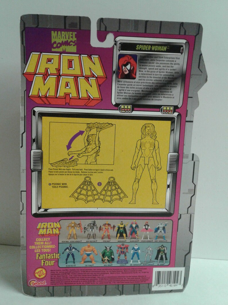 May include: Back of a pink and white cardboard package for a Spider-Woman action figure. The package features a photo of the figure and a description of the character. The text reads "Spider-Woman". The package also includes a photo of the figure's web and instructions on how to use it. The package also includes a photo of other action figures from the same series, including Iron Man, Fantastic Four, and others.