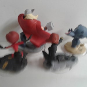 May include: A set of four Disney Infinity figures, including Thor, Black Widow, Stitch, and Ant-Man. The figures are in various poses and are ready for action.