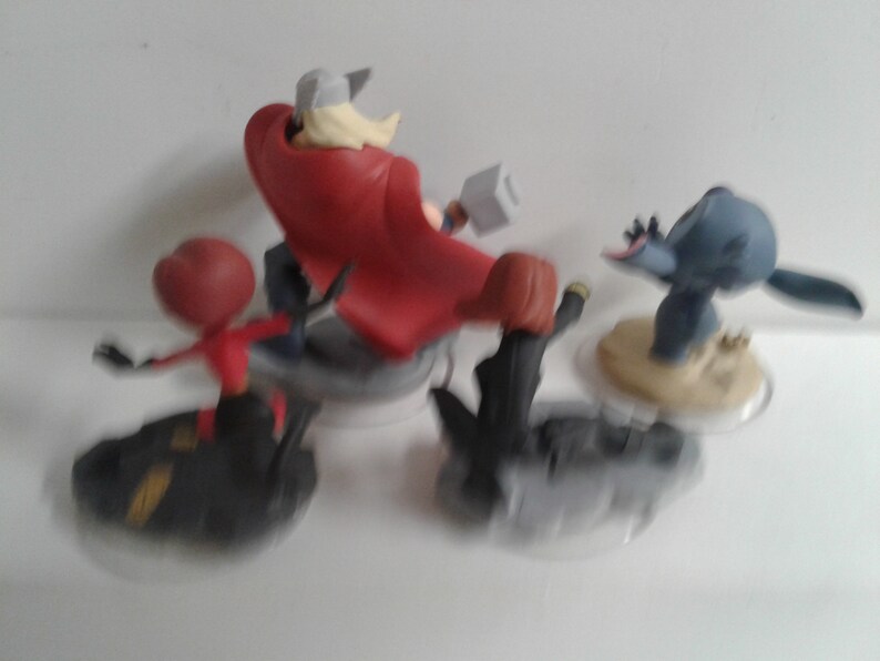 May include: A set of four Disney Infinity figures, including Thor, Black Widow, Stitch, and Ant-Man. The figures are in various poses and are ready for action.