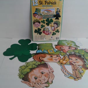 May include: A set of 12 St. Patrick's Day decorations featuring green shamrocks, leprechauns, and the text "Ireland Forever".